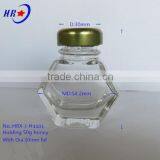 Holding 50g Honey Glass Jar With Golden Lid