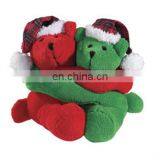 Red and green hug two teddy bear toys for Christmas holiday