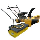 Snow thrower with sweeping attachment