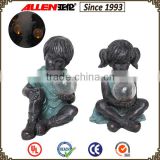 Retro style 7.9*9.1*12 bronze holding solar light ball girl and boy sculputure for garden resin sculpture