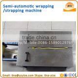 Low Desk Semi Automatic Carton Box Strapping Machine pp Strapping Roll Making Machine