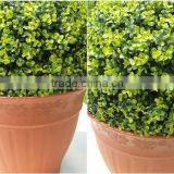 Artificial green ball with buxus leaves