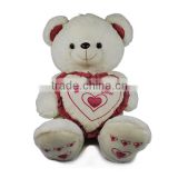 Lovely stuffed bear holding a heart