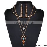 Gold triangle with turquoise and crystal necklace with matching gold tassel earrings