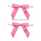 Pink satin ribbon bow with wire twist tie