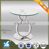 small round glass and steel coffee table