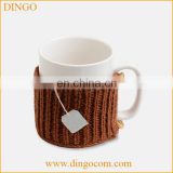 Ceramic coffee mug with knitted sleeve cover