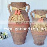 terracotta flower vase with straw and two small clay pots