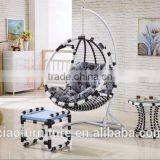 Round Wicker Hanging Chair In Room With Ottoman thumbnail-1