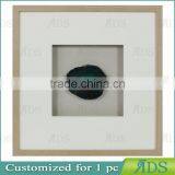 Shadow Box Frame With A Light Gray Wash And Encasing Colorful Natural Agate Under Glass