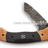 A HANDMADE ENGRAVED RED COPPERBOLSTERS WITH BUFFALO HORN HANDLE, DAMASCUS STEEL LINER LOCK FOLDING KNIFE thumbnail-1