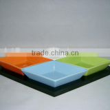 Colorful ceramic snack plates with wooden tray