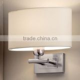 white oval fabric shade wall lamps in satin nickel backplate