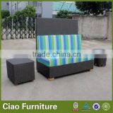 Outdoor Rattan Bench With Colorful Cushion Sitting