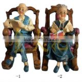 Polyresin couple statues in chair