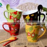 Colorful stoneware coffee mug with spoon from factory