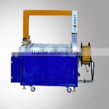 Full-automatic high table carton packing/strapping machine