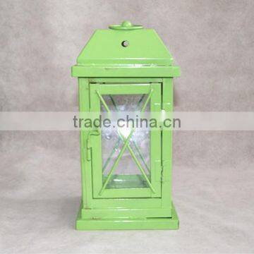 green metal lantern with clear glass wall