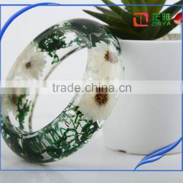 Pine needles inside transparent clear acrylic bangle stand