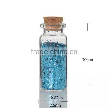 Corked Glass Packaging Bottles Filled With Blue Cosmetic Powder Glitters