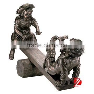 Bronze garden boy girl statue playing seesaw