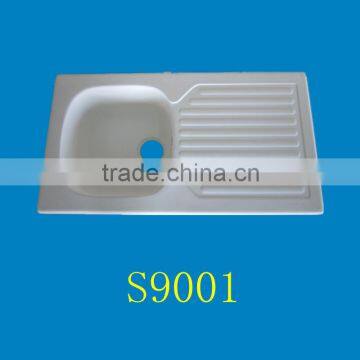 countertop above white acrylic kitchen sink with draining board