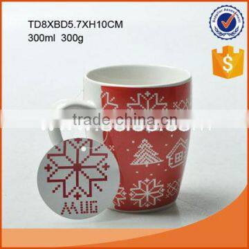 Ceramic Christmas mug in red color with Christmas tree and snow flake pattern