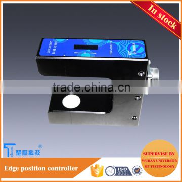 Non transparent material handling equipment web guiding with ultrasonic position sensor