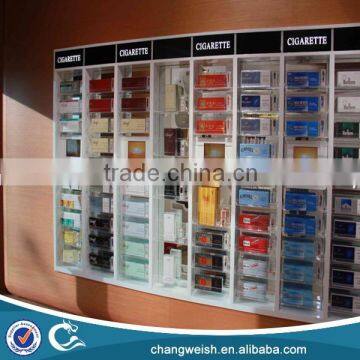 white color cigarette display unit cabinet attached against the wall