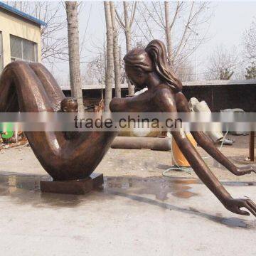 Bronze abstract baby on mother's body sculpture