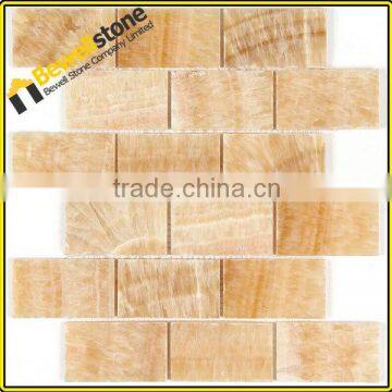 Honed 2" brick shaped yellow onyx subway tiles for entranceway