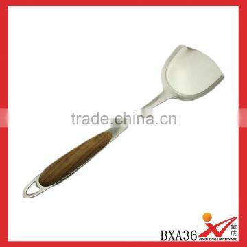 Professional stainless steel cooking spatula with wood handle