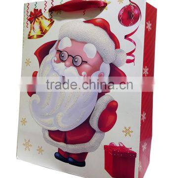 Santa paper gift bag with colorful glitter and satin ribbon handle