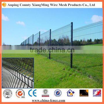 Green welded wire mesh fence with three wave guardrail