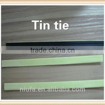 Adhesive plastic tin ties for reclosing coffe bag