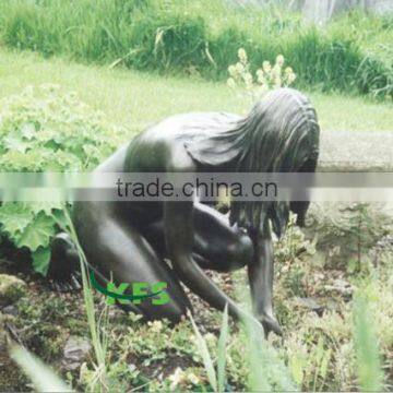 Brass nude lady washing hands by lake