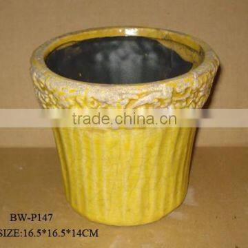 yellow painted ceramic garden pot