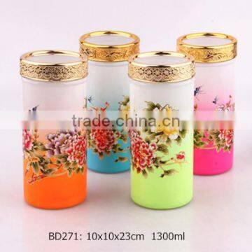 glass storage jar with decal and golden lid