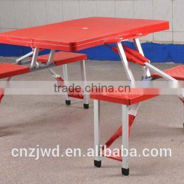 Outdoor plastic folding picnic table with 4 seats color red