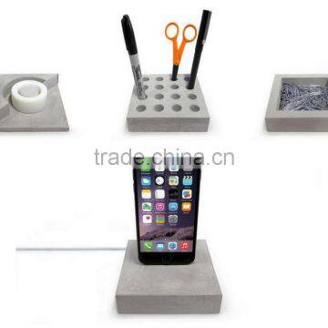 solid concrete desk accessories hold paperclips, pens, a roll of tape , smartphone holer