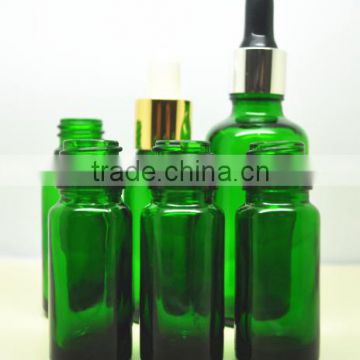 green glass bottle with metal dropper for essential oil