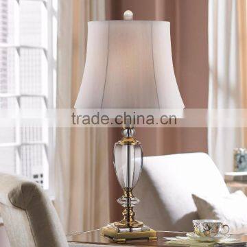 11.1-3 A footed stand in brass holds urn shape faceted sparkling clear Bright Crystal and Brass Table Lamp