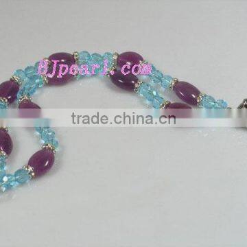 7.5" 2 rows 8mm round blue faceted crystal and oval purple gemstone bracelet.