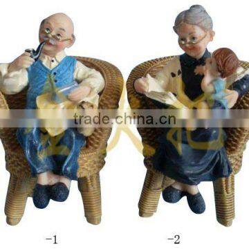 Resin couple figurine sitting in chair