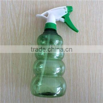 green transparent plastic garden spray bottle with trigger