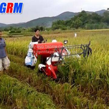 Cheapest price mini rice combine harvester / rice reaper working in muddy field