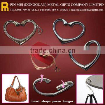 Rotating heart shape bag hanger