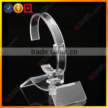 Single clear acrylic watch display stand on countertop