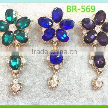 Colored crystal and rhinestone flower brooches for party invitation