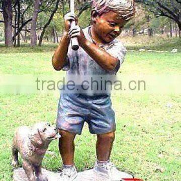 Bronze baseball boy statue with a dog in garden